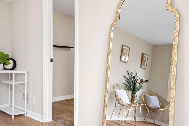 hallway with baseboards and wood finished floors