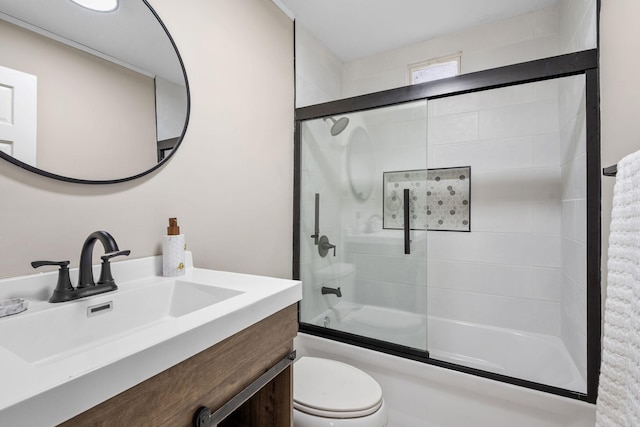 full bath with bath / shower combo with glass door, toilet, and vanity