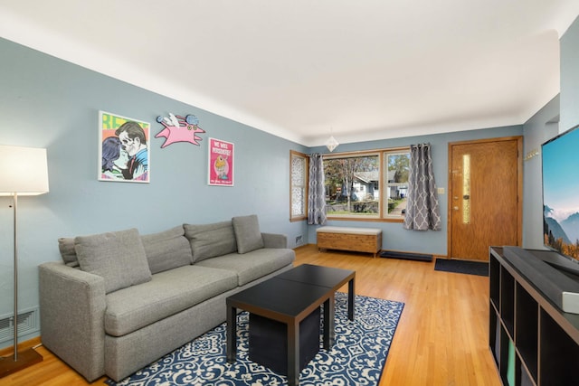 living area with light wood-style flooring and visible vents