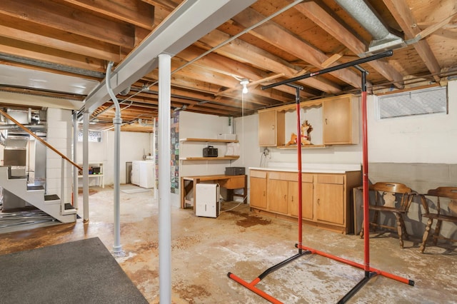 unfinished basement with washer and dryer and stairway