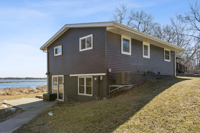 view of home's exterior with a water view and cooling unit
