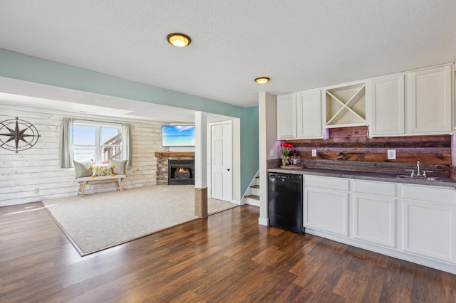kitchen with open floor plan, refrigerator, and white cabinetry