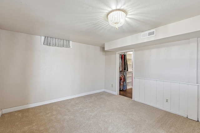 finished basement with carpet flooring, baseboards, and visible vents