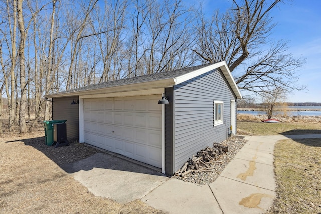 detached garage with a water view