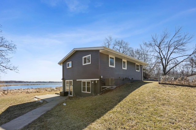 view of home's exterior with a water view, a yard, and central air condition unit