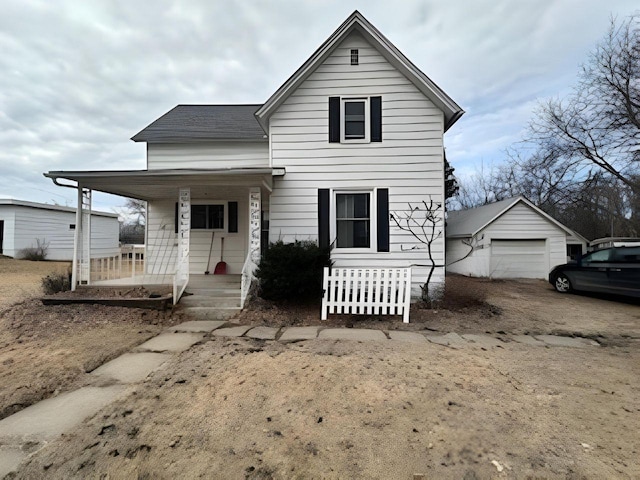 208 Dugan St S, Welcome, MN 56181 - view of front facade with covered porch and a garage