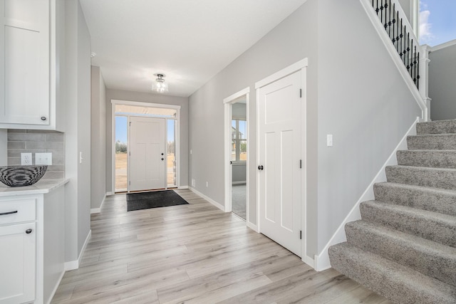 21057 Tippecanoe St NE, East Bethel, MN 55011 - entryway featuring stairway and light wood finished floors