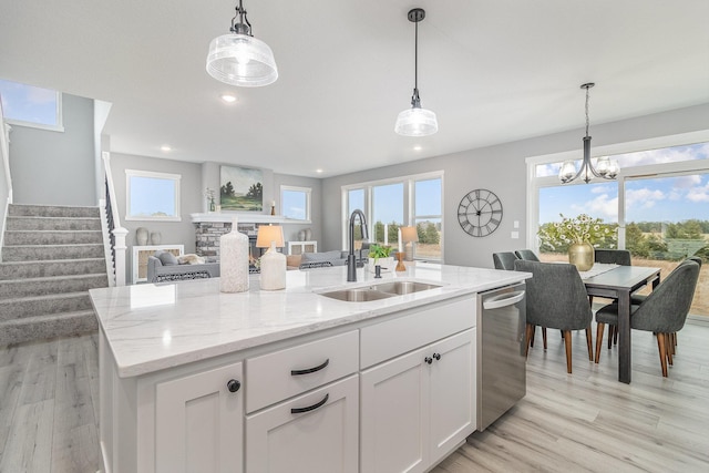 21057 Tippecanoe St NE, East Bethel, MN 55011 - kitchen with stainless steel dishwasher, open floor plan, light wood-style flooring, white cabinets, and recessed lighting