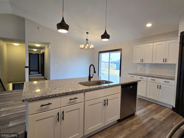602 Warren St, Janesville, MN 56048 - kitchen with vaulted ceiling, dark wood-style flooring, stainless steel dishwasher, a sink, and white cabinets