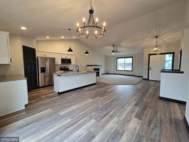 602 Warren St, Janesville, MN 56048 - kitchen featuring ceiling fan with notable chandelier, dark wood finished floors, a sink, white cabinets, and appliances with stainless steel finishes