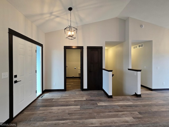 602 Warren St, Janesville, MN 56048 - foyer featuring baseboards, lofted ceiling, and wood finished floors