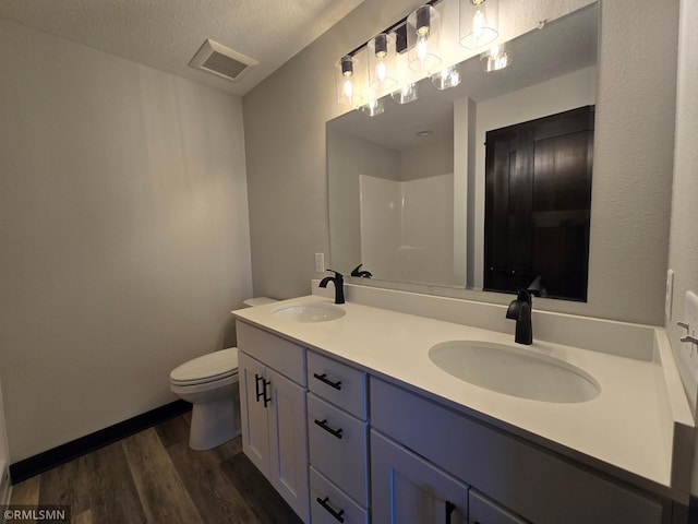 602 Warren St, Janesville, MN 56048 - full bath featuring wood finished floors, a sink, toilet, and visible vents