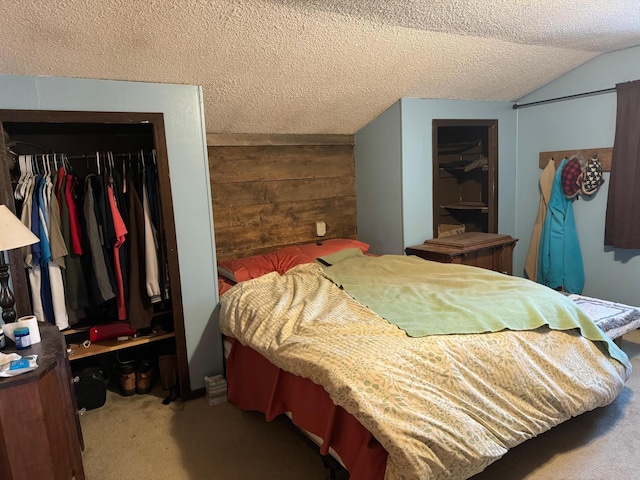carpeted bedroom with a closet, lofted ceiling, a textured ceiling, and wood walls