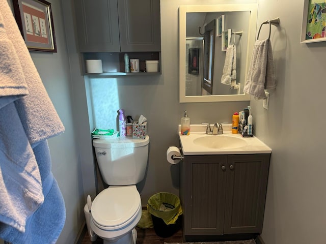 bathroom featuring toilet and vanity