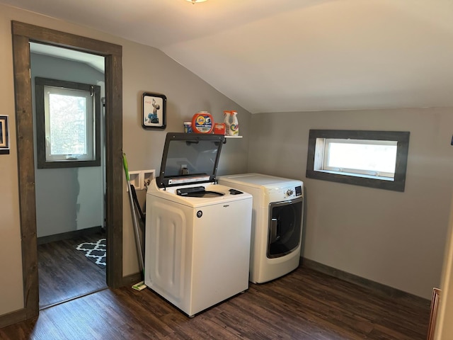 clothes washing area featuring washing machine and dryer, dark wood-style floors, and a wealth of natural light