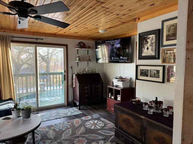 living area featuring a textured wall, ceiling fan, wood finished floors, and wood ceiling