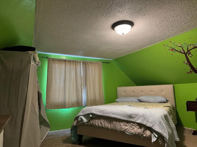 carpeted bedroom with a textured ceiling and vaulted ceiling