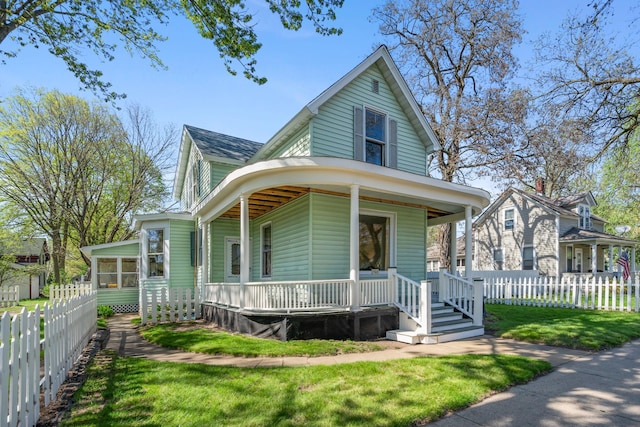 507 Cascade St N, Osceola, WI 54020 - view of front of property with a porch, a shingled roof, and a sunroom