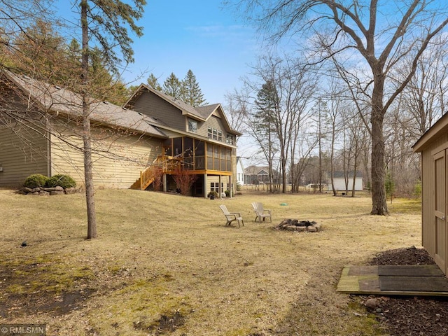 view of yard featuring a sunroom and stairs