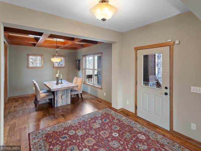 dining space with baseboards, wood finished floors, and coffered ceiling