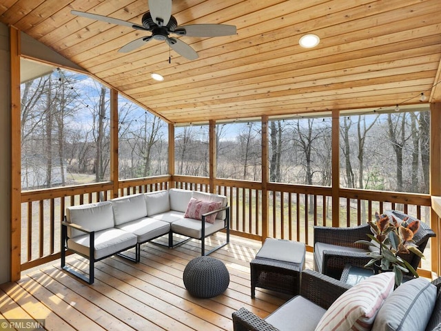 sunroom / solarium featuring a ceiling fan and an outdoor living space