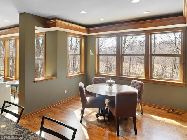 dining area featuring baseboards, visible vents, wood finished floors, and recessed lighting