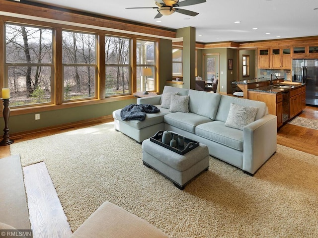 living area with recessed lighting, a ceiling fan, visible vents, baseboards, and wood finished floors