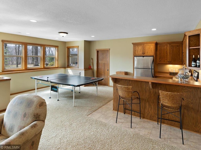 playroom with recessed lighting, light tile patterned floors, light carpet, baseboards, and a textured ceiling