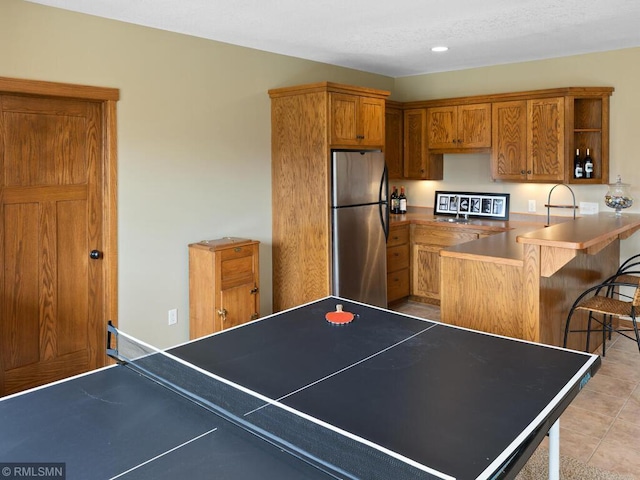 recreation room with light tile patterned floors