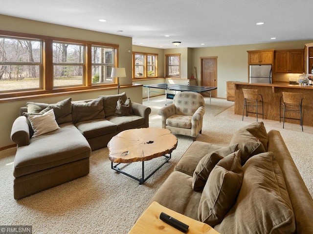 living area with recessed lighting and light colored carpet