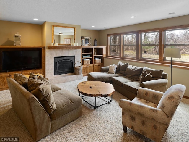 carpeted living room with a fireplace and recessed lighting