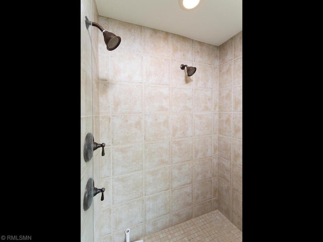 bathroom with tiled shower