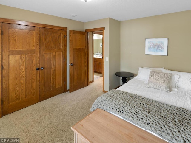 bedroom with a closet and light colored carpet