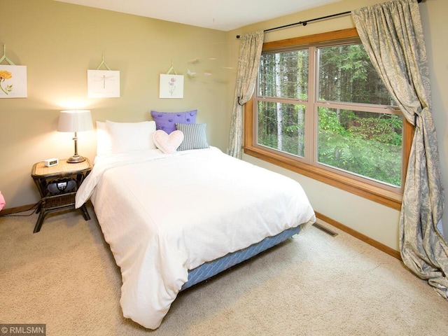bedroom with visible vents, carpet, and baseboards