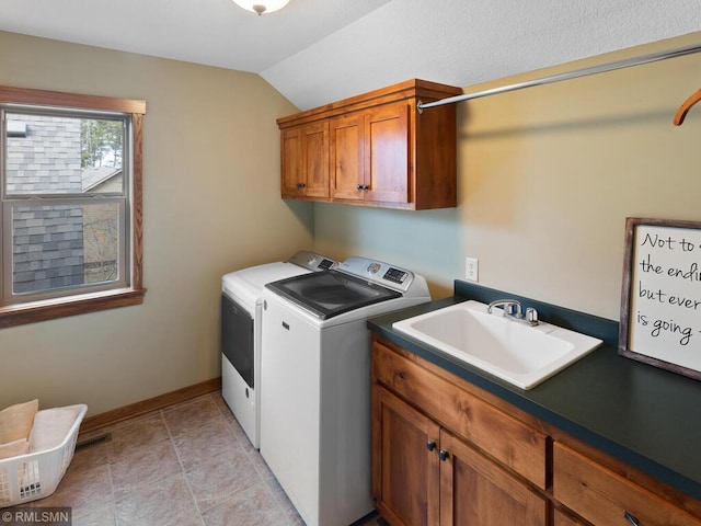 laundry room with washer and clothes dryer, cabinet space, baseboards, and a sink