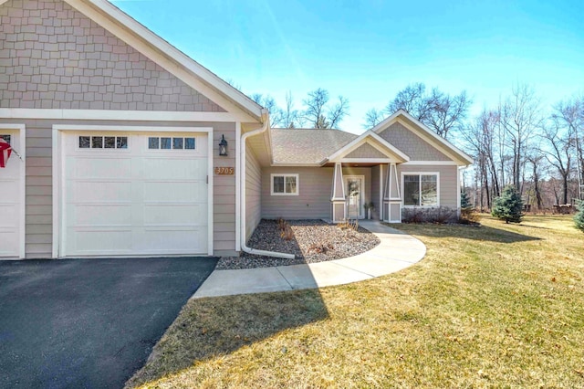 view of front facade with an attached garage and a front lawn