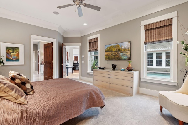 bedroom featuring ornamental molding, baseboards, a ceiling fan, and light colored carpet
