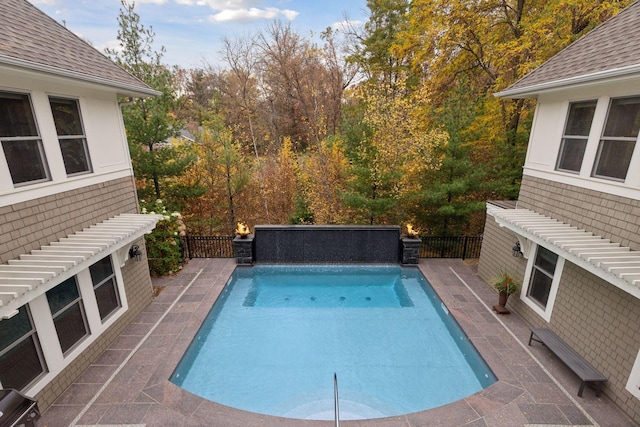 view of swimming pool featuring a patio area, fence, and a fenced in pool