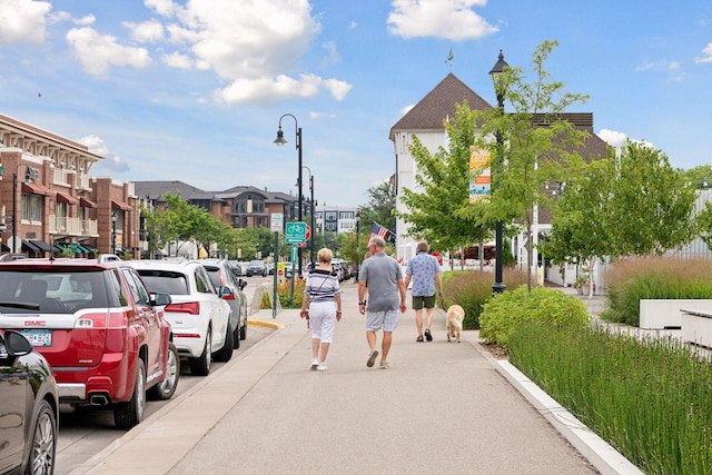 view of road with sidewalks, a residential view, and street lighting