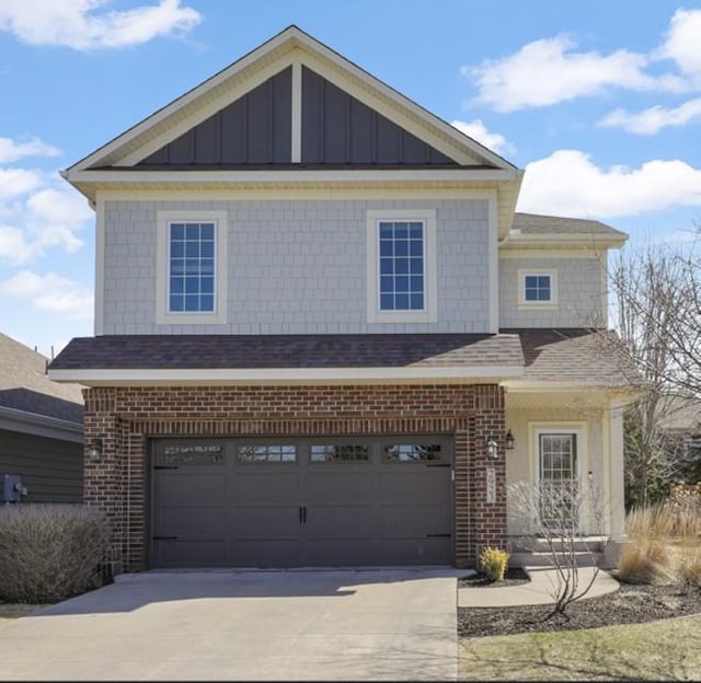 2923 124th Cir NE, Blaine, MN 55449 - view of front of house with brick siding, driveway, board and batten siding, and an attached garage