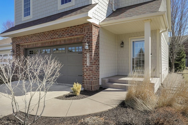 2923 124th Cir NE, Blaine, MN 55449 - entrance to property with a garage, a shingled roof, brick siding, and concrete driveway