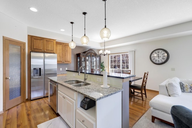 2923 124th Cir NE, Blaine, MN 55449 - kitchen with a sink, stainless steel appliances, light stone counters, recessed lighting, and light wood-style floors