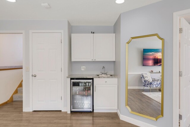 2923 124th Cir NE, Blaine, MN 55449 - indoor wet bar featuring beverage cooler, wood finished floors, baseboards, and recessed lighting