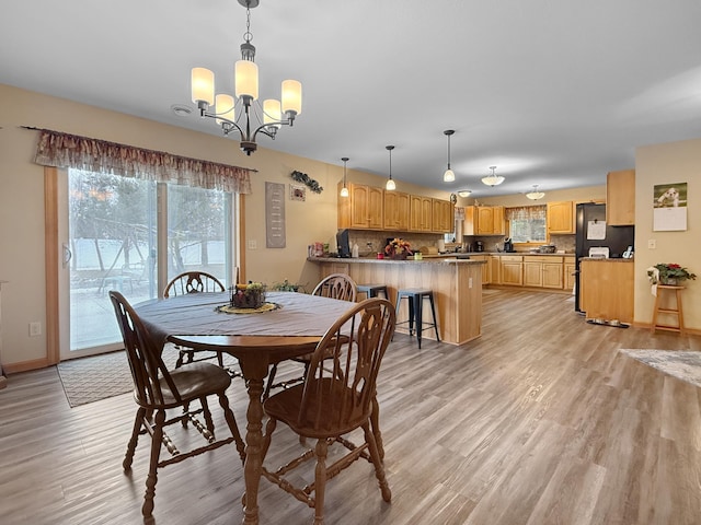 4886 Feelinrite Ln NW, Eckles Twp, MN 56601 - dining room featuring a chandelier, light wood finished floors, and baseboards