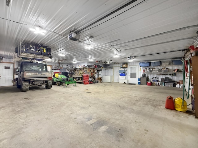 4886 Feelinrite Ln NW, Eckles Twp, MN 56601 - garage featuring a garage door opener and a workshop area