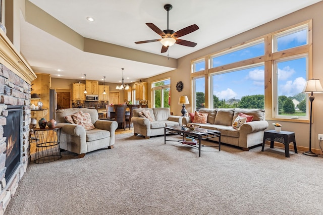 17623 Grist Ct SW, Prior Lake, MN 55372 - living room with a fireplace, light colored carpet, a ceiling fan, a chandelier, and recessed lighting