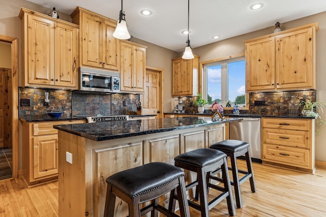 17623 Grist Ct SW, Prior Lake, MN 55372 - kitchen featuring appliances with stainless steel finishes, recessed lighting, a center island, light wood-style flooring, and light brown cabinetry