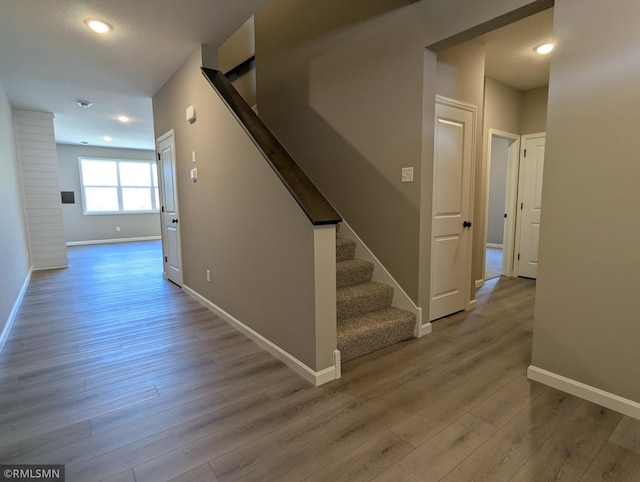6752 104th St, Cottage Grove, MN 55016 - hall with stairs, wood finished floors, baseboards, and recessed lighting