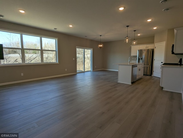 6752 104th St, Cottage Grove, MN 55016 - kitchen with stainless steel appliances, open floor plan, a sink, baseboards, and dark wood finished floors