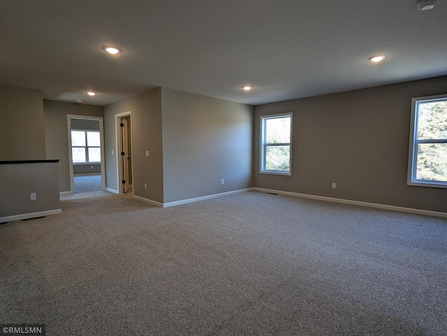 6752 104th St, Cottage Grove, MN 55016 - carpeted empty room featuring recessed lighting, baseboards, and plenty of natural light